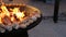 Pieces of fish steak are grilled. Fish is being prepared on a round steel iron outdoor grill with a cooktop and an open