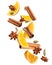 Pieces of fresh orange, aromatic anise stars, cinnamon and cardamom falling on white background