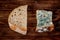 Pieces of fresh and stale bread on a dark wooden background_