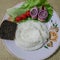 Pieces of herring with rings of blue onion on a sheet of lettuce