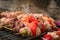 Pieces of meat and vegetable skewers on the grill at a typical argentinian barbecue.