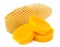 Pieces of natural beeswax and a piece of honey cell are isolated on a white background. Beekeeping products. Apitherapy.