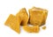 Pieces of organic beeswax on a white background. The use of beeswax in apitherapy. Production Ingredient for Medical and