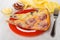 Pieces of pizza in plate, ketchup, mayonnaise inbowls, napkin, f