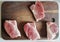Pieces of pork lie on the board before the roast. Pork steaks. Pork on chops. Bright, juicy meat. Crans meat.