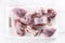Pieces of portioned rabbit on a white cutting board - Top of view