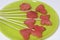 Pieces of the pulp of watermelon are cut with a stamp. They are given different forms. Stringed on skewers for a picnic.