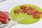 Pieces of the pulp of watermelon are cut with a stamp. They are given different forms. Stringed on skewers for a picnic. Next to t