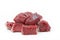 Pieces of raw beef goulash on white