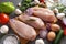 Pieces of raw chicken fillet on a cutting Board, meat, vegetables, herbs, tomato, onion, parsley, oil, pepper, eggs, cucumber,