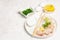 Pieces of raw hake, chukka salad, lemon wedge, fresh herbs, eggs as food preparation concept