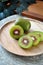 Pieces of Red Kiwifruit on Wooden Plate