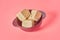 Pieces of sunflower halva lies in bowl on pink background