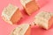 Pieces of sunflower halva on pink background