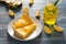 Pieces of tasty lemon pie and mason jar with drink on wooden table