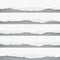 Pieces of torn white blank paper on gray squared, striped background