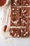 Pieces of vegan sweet potato brownie on white background, top vi