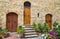 Pienza, Italy â€“ July 22, 2017: Three wooden front doors in the home. Typical doors on a stone wall in the Tuscany town Pienza.