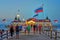 Pier Ahlbeck on the Baltic Sea with national flags in the wind. - Letters with Historische SeebrÃ¼cke Ahlbeck means Ahlbeck