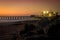 Pier on the Atlantic Ocean in Swakompund, Namibia. Beautiful sunset with a bright sky and soft gentle water