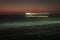 Pier on the Atlantic Ocean in Swakompund, Namibia. Beautiful sunset with a bright sky and soft gentle water