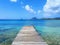 Pier at beach in Landscape of the French West Indies. The wooden bridge stretches into the sea. Beautiful tropical with Mountain
