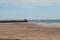 Pier and beach with old sailing yacht at Berwick-upon-Tweed
