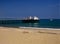 Pier and boat on Malibu beach