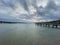 Pier with calm lake `Starnberger See` in Bavaria with smooth cloudy sky