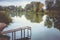 Pier on a calm river in the summer. Wooden pier bridge