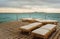 Pier with chaise longues in the sea in resort. Summer vacation.