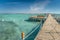 Pier with chaise longues in the sea in resort. Summer vacation. View at a clear sea with turquoise water. Summer vacation at a sea