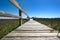 A pier extending over a salt-marsh.