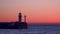A pier with a flashing lighthouse at dawn. Yalta Crimea
