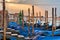 Pier gondolas near Piazza San Marco in Venice at sunrise.