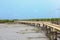 Pier or jetty, footpath promenade, and sea at sunrise. Beautiful view of pier or jetty for background. The Tourist passing Jetty.