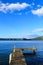 Pier on Lake Rotoiti, New Zealand, looking towards wide open blue skies