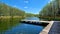 A pier on a lake in the woods in Poland