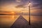 Pier with lanterns at sunset