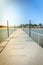 Pier leading to the sea on a sunny day/empty pier overlooking the sea on a sunny day