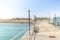 Pier leading to the sea on a sunny day/empty pier overlooking the sea on a sunny day