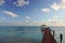 A pier leads out into a tropical lagoon under a bright blue sky on the island of Fakarava in French Polynesia