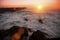 Pier in the Ocean, during amazing bloody sunset. Nature.