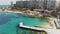 Pier over the warm Mediterranean sea on Sliema\\\'s seaside, in Malta - Slow Orbit aerial shot