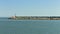 The pier of Pesaro harbor with breakwater cliffs, a colored wall and a small red lighthouse Italy, Europe