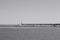 The pier of Pesaro harbor with breakwater cliffs, a colored wall and a small red lighthouse Italy, Europe