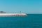 The pier of Pesaro harbor with breakwater tetrapods and a small green lighthouse Italy, Europe