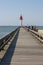 Pier and red lighthouse on the coast of Trouville