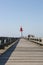 Pier and red lighthouse on the coast of Trouville