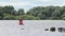 Pier with river against green trees